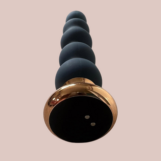 An angled view of the anal bead vibrator, the vibrator can be controlled on the base.