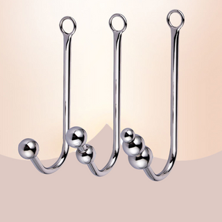 An image showing all three anall ball hooks, from left to right is the single ball, double ball and three ball anal hooks at House Of Chastity.