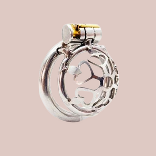 An angled side view of the Cage Of Hearts from House Of Chastity. You can see it fully assembled with its base ring and integral lock in place.