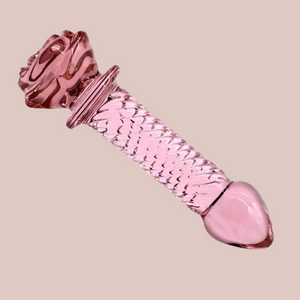 An angled view of the rose pink glass dildo, you can see the full length and easy to hold head.