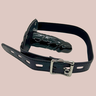 Showing the large black penis gag, you can see cock length  and the silver buckle which can be padlocked. The padlock is included.