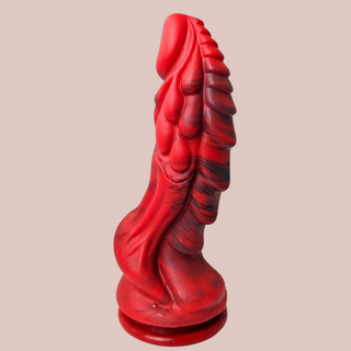 The dragon force dildo from a side profile in red and black. You can see the shaped detailing to the body that is designed with pleasure in mind.