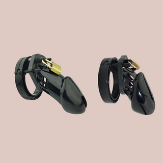 A black medical grade plastic chastity cage that is shown in both sizes available, standard on the left and small on the right. This product has a chastity cage, different sized base rings, an external padlock and extra numbered locks.