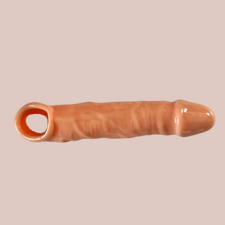 The flesh coloured Penis Sleeve/Extender, you can see the hole for the testicles to be set through.