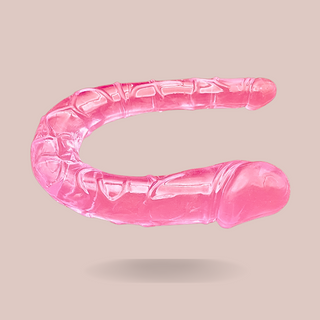 Showing the Small Pink Jelly Double Ended Dildo from House Of Chastity, you can see the two ends that differ in size, it has a lovely pink tone whilst being see-through.