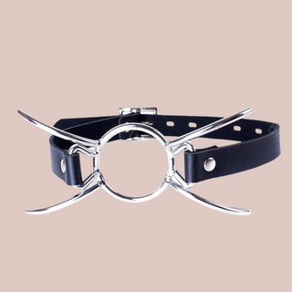 This image shows the black gag straight[, the centre O-ring and the 4 legs that will spread across the face.  