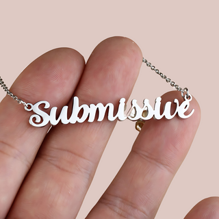 A close up of the Submissive necklace held on a hand .