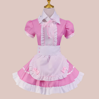 The Suzie pink maids dress, shown with its pink dress, white frilled bib, white frilled edging to the skirt, neck and sleeves, white collar and white half apron with pink bows.