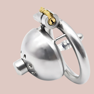 The Ultra Urethral is a stainless steel (metal) chastity cage, it has a closed domed end with circular air holes patterned around the centre hole, the centre allows the urethral tube to be fixed into place or removed. The base ring when fixed to the cock cage, allows the integral lock to be locked..