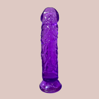 The Purple Translucent Jelly Dildo shown sat on its suction cup base.